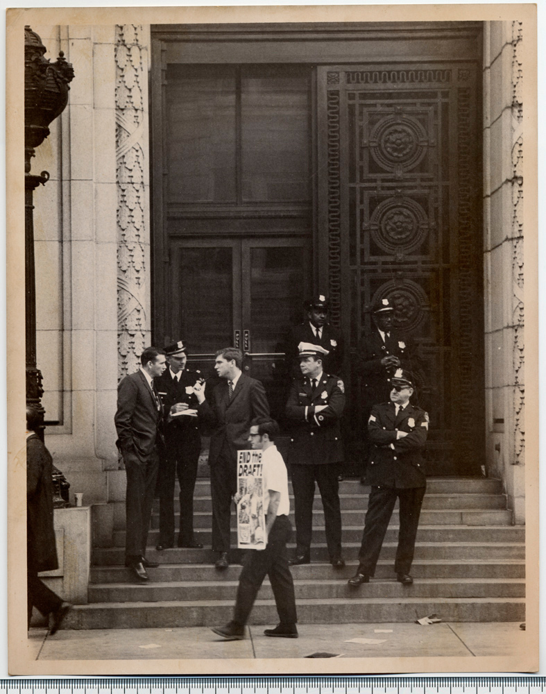 Officers on steps of the United States Customs House in Baltimore facing an anti-draft protest during the trial of the Catonsville Nine in October 1968